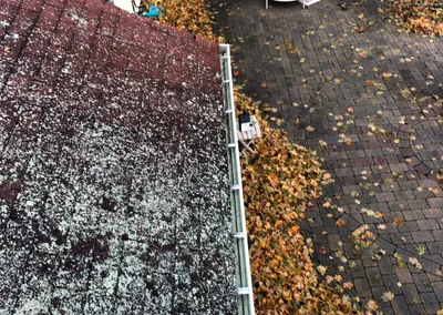After cleaning — the same roofline with the gutter cleared along its full run