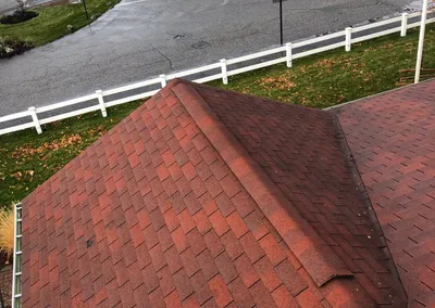 After cleaning — the red shingle roof and gutter cleared of leaves