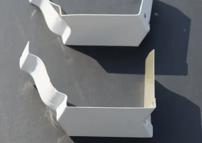 Pair of white aluminum bay mitre gutter corner pieces