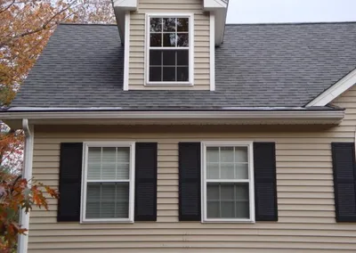 Close view of Gutter Cap over a dormer on a tan house
