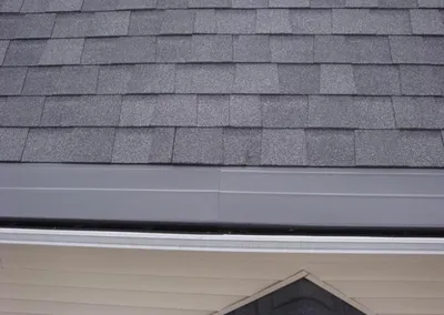 Close-up of the Gutter Cap dome covering the gutter at the roof edge
