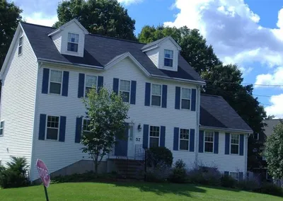 Large colonial with Gutter Cap installed, seen from the front lawn
