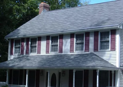 Gutter Cap across the long front porch roof of a colonial home