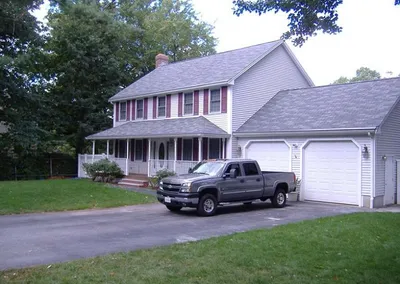 Two-story home and garage with Gutter Cap on every run