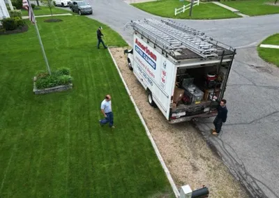 Crew truck at the curb during a Gutter Cap installation