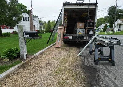 Unloading Gutter Cap stock from the installation truck