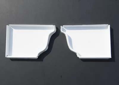 Left and right white gutter endcaps side by side