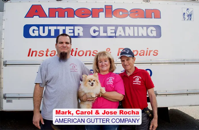 Mark, Carol and Jose Rocha of American Gutter, with their dog, in front of a company truck