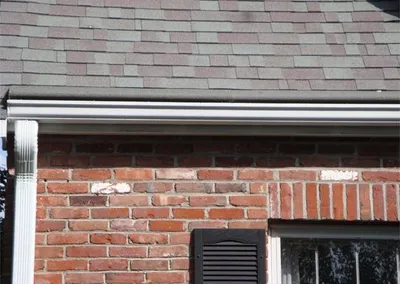 Gutter Roof installed over the gutter of a brick home