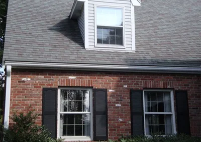 Brick colonial with Gutter Roof along the front roofline