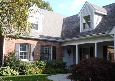 Cape home with dormers protected by Gutter Roof