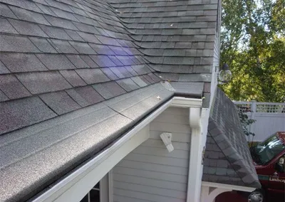 Gutter Roof following the eave of a shingled roof