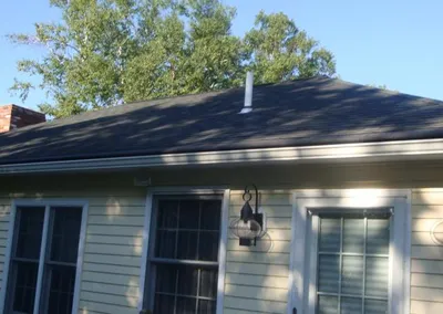 Gutter Roof across the front of a yellow single-story home