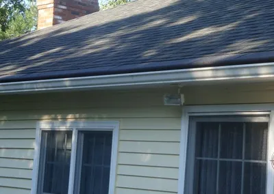 Gutter Roof over the entry of a cream-colored home