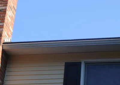 Gutter Roof beside a brick chimney