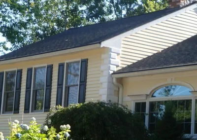 Gutter Roof on a yellow colonial with a bay window