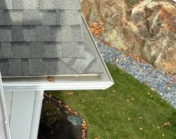 Screened gutter at a roof corner seen from above