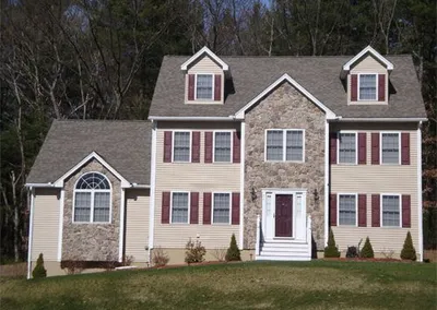 Completed gutters on a large stone-front colonial home