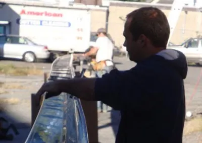 Crew member carrying formed seamless gutter stock