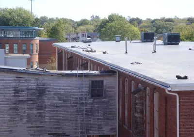 Commercial gutter work on a flat-roof brick building