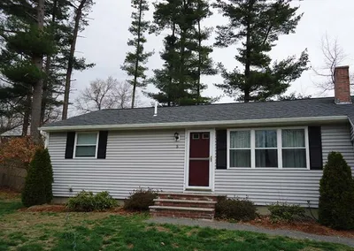 Completed seamless gutters on a gray ranch home